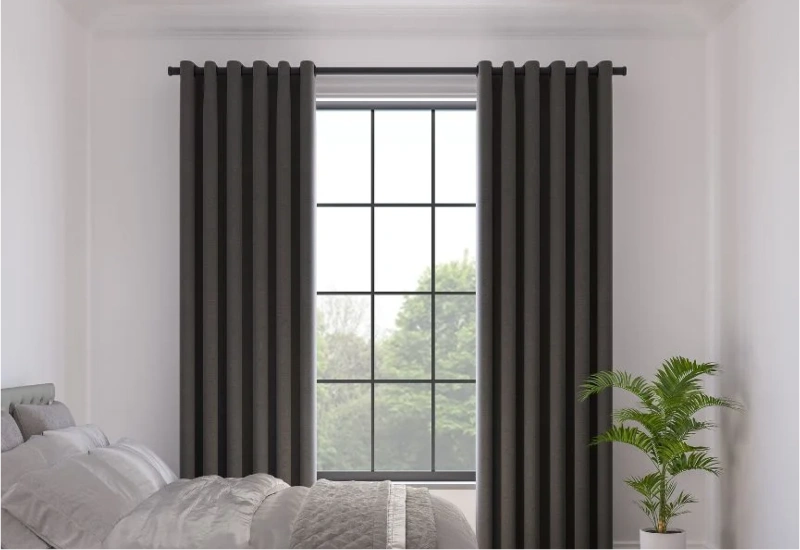 Modern grey eyelet curtains in bedroom