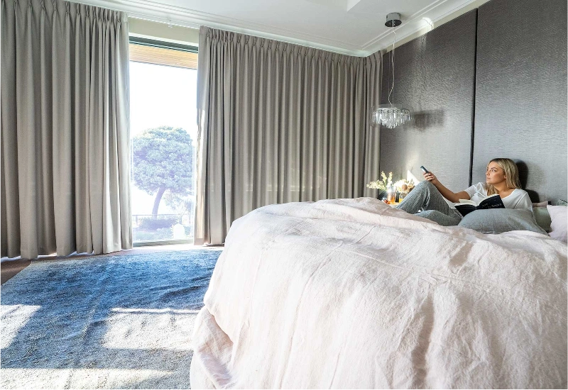 Motorized curtains in smart luxury bedroom