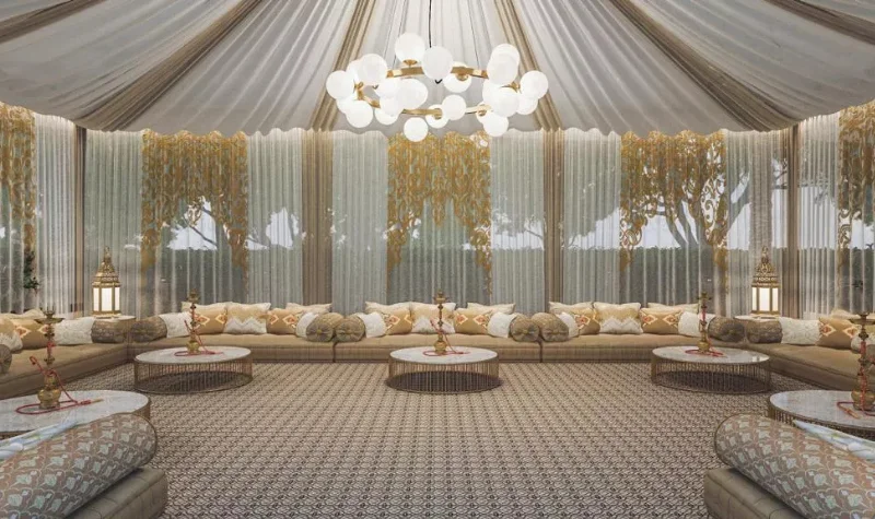 Traditional tent majlis with golden décor and seating