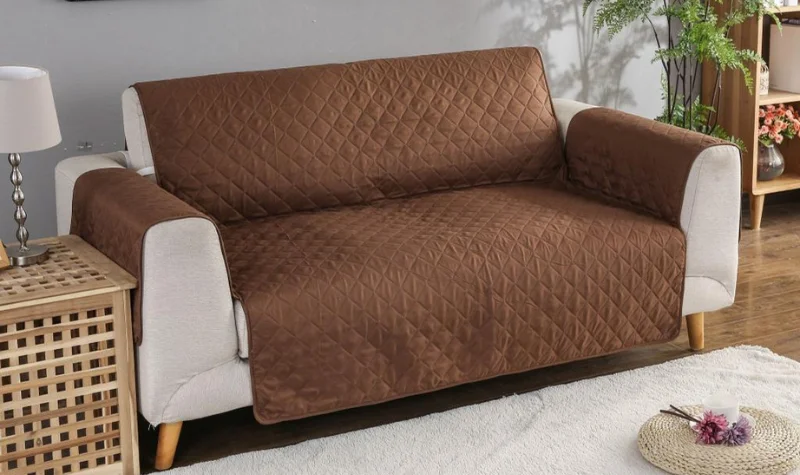 Brown quilted sofa cover on light beige sofa with modern home decor in Dubai