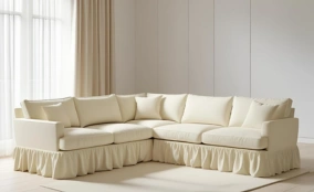 Cream fabric sofa cover with ruffled skirt in Dubai living room