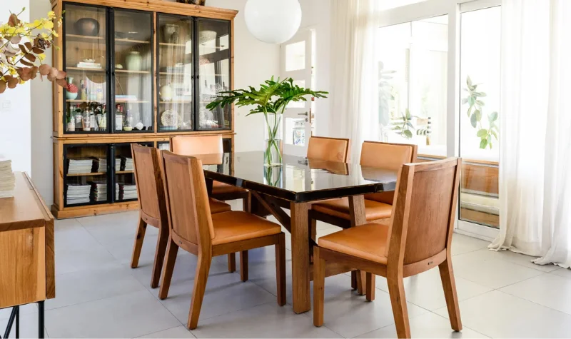 Polished wooden dining table and chairs in Dubai with glossy finish
