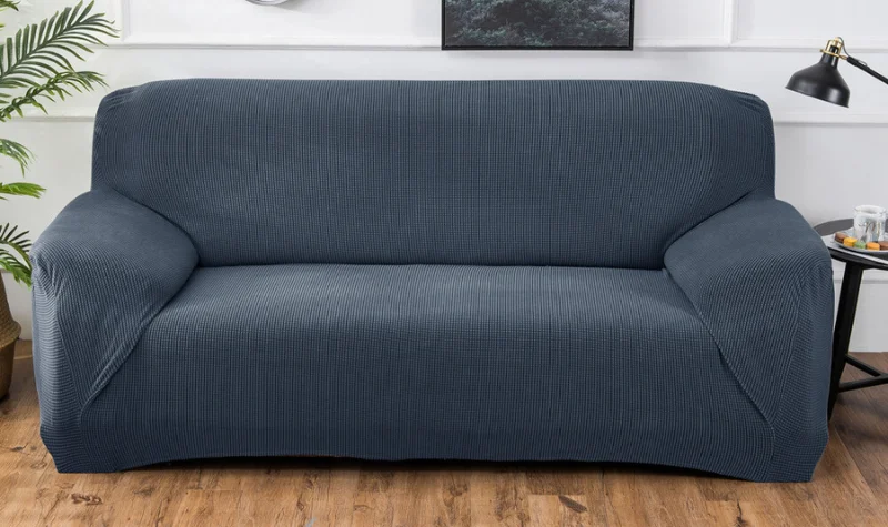 Dark blue elastic stretch sofa cover on modern sofa in Dubai interior