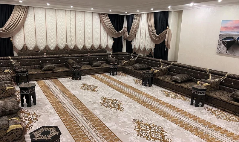Classic majlis seating with patterned carpet and curtains