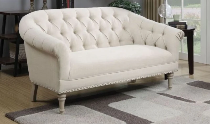 Modern beige tufted sofa with nailhead trim
