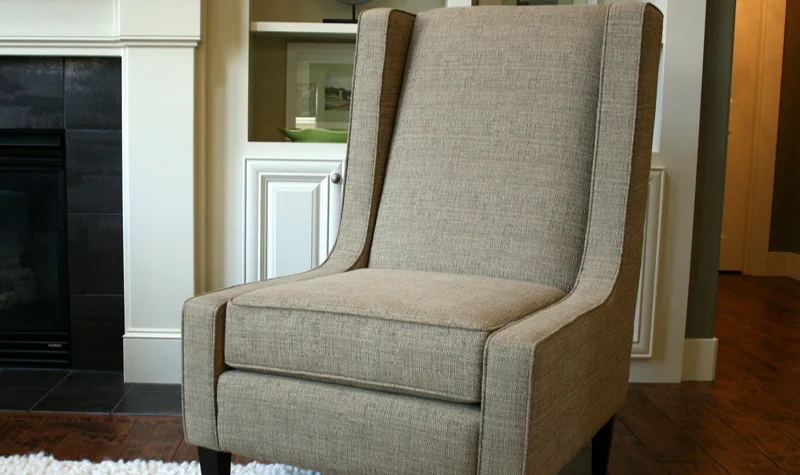 Beige fabric armchair with trim