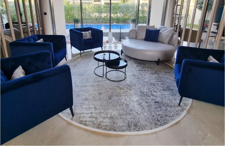 Soft circular rugs for balanced interior layouts.