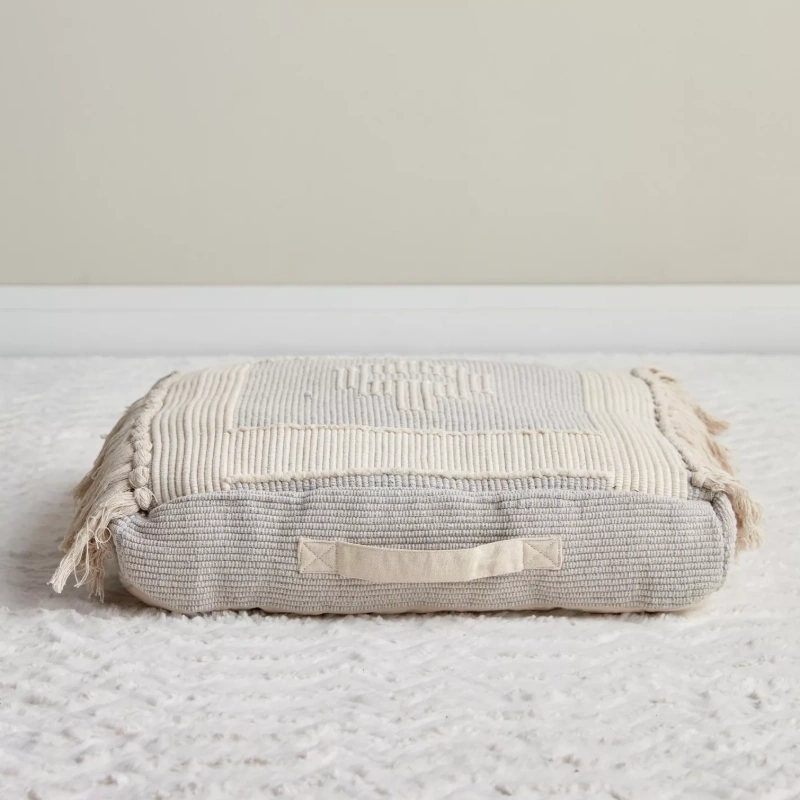 Neutral colored floor cushion close up